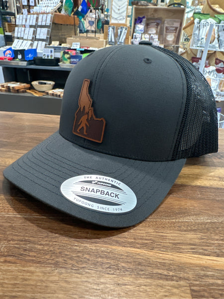 Idaho Yeti Leather Patch on a Charcoal and Black Adjustable Trucker Hat